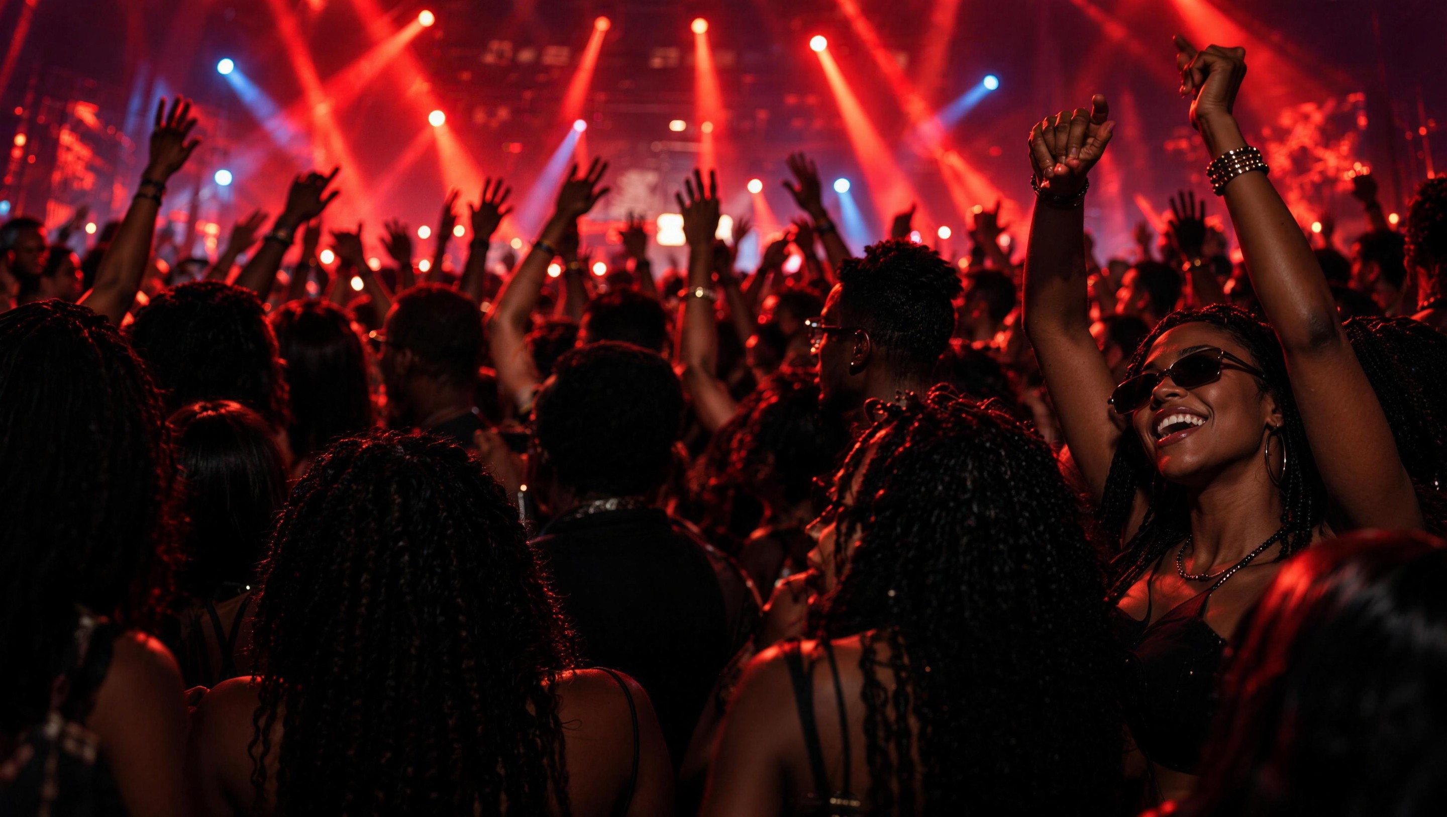 Back of the crowd with raised hands at an AFROLAND UNRATED event